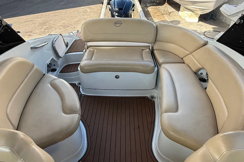 Slide: The Image of 2018 Crownline Eclipse E24 XS boat interior with cushioned seating and teak-style flooring. - 21