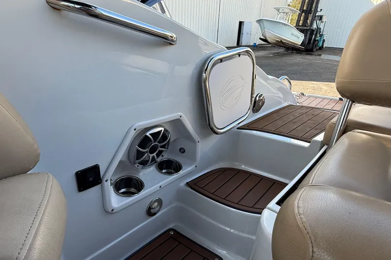 Slide: The Image of Close-up of 2018 Crownline Eclipse E24 XS boat deck with finger pointing at surface. - 22