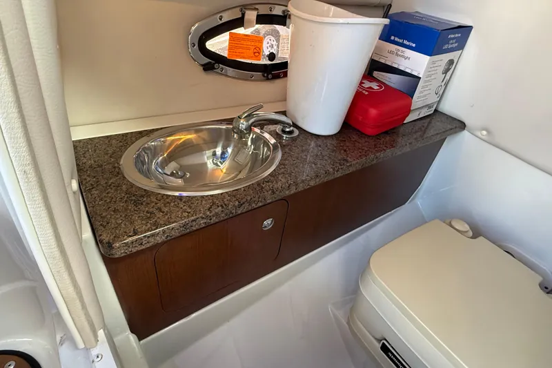 Slide: The Image of 2018 Crownline Eclipse E24 XS boat interior with sink, countertop, and storage. - 33