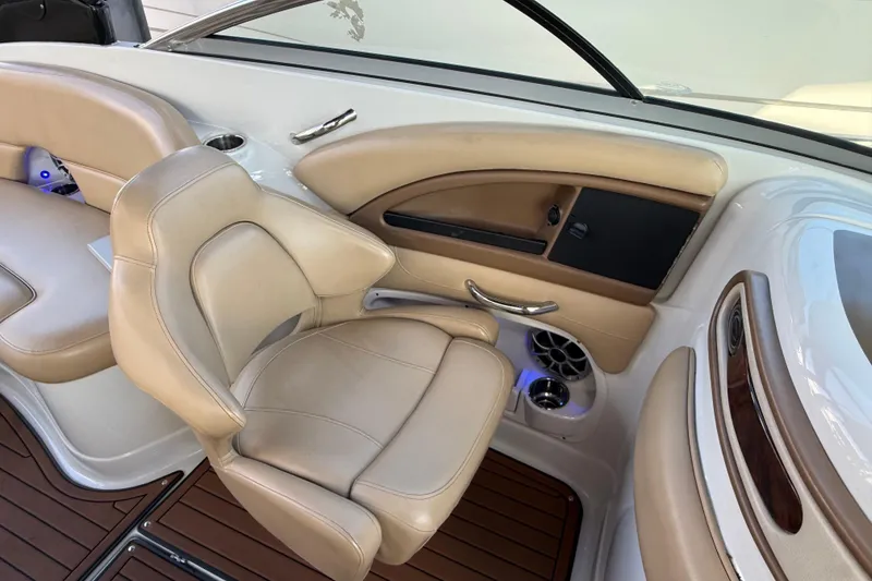 Slide: The Image of 2018 Crownline Eclipse E24 XS interior with beige seating and wood accents. - 34