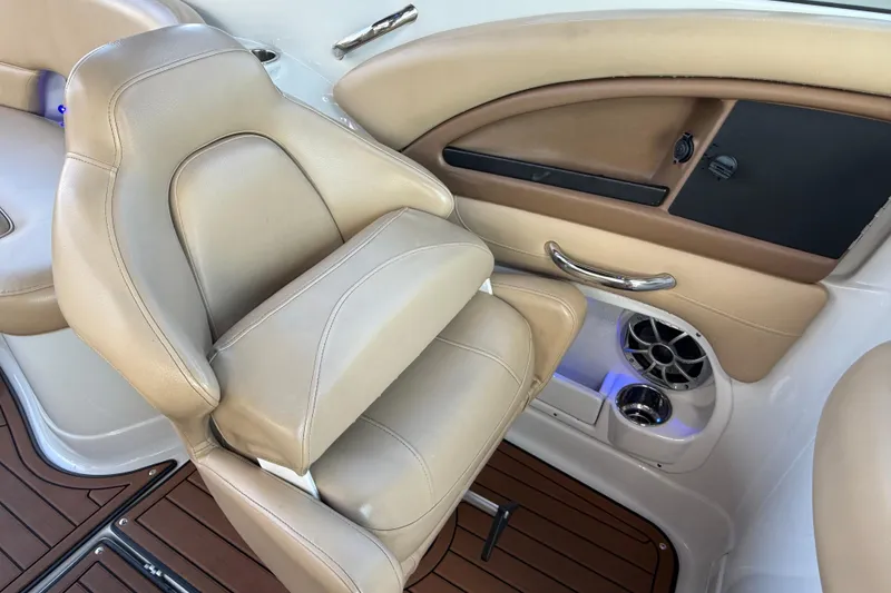 Slide: The Image of 2018 Crownline Eclipse E24 XS boat interior with beige seating and wood flooring. - 35