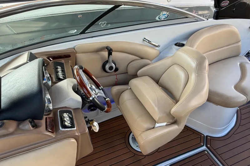 Slide: The Image of 2018 Crownline Eclipse E24 XS boat interior with beige seating and wooden accents. - 36