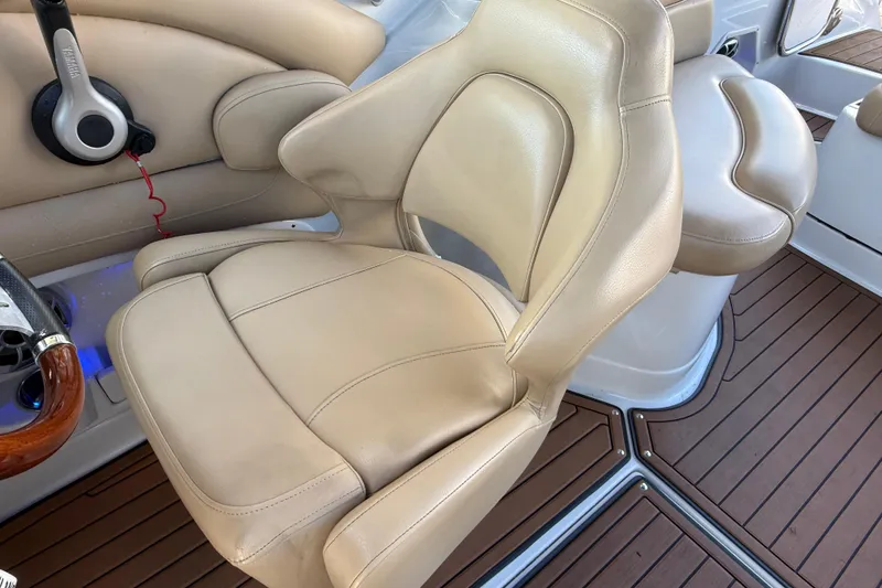 Slide: The Image of 2018 Crownline Eclipse E24 XS boat interior with beige leather seating and wood accents. - 37