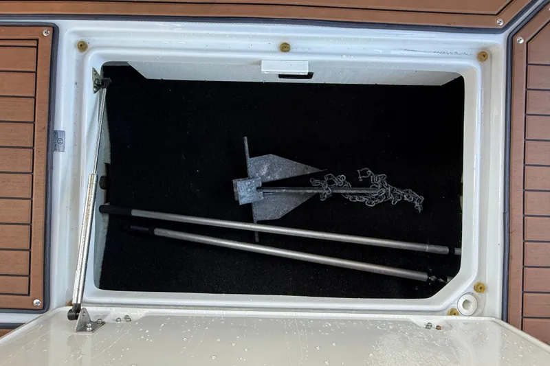 Slide: The Image of Storage compartment of 2018 Crownline Eclipse E24 XS with anchor and poles. - 38