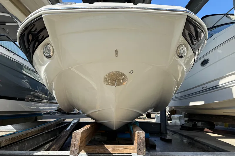 Slide: The Image of 2018 Crownline Eclipse E24 XS boat on a lift, covered and docked. - 4