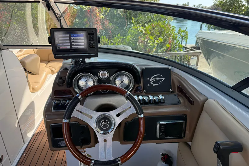 Slide: The Image of 2018 Crownline Eclipse E24 XS boat dashboard with steering wheel and navigation system. - 40