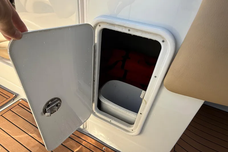 Slide: The Image of 2018 Crownline Eclipse E24 XS boat interior with tan leather seats and wooden flooring. - 51