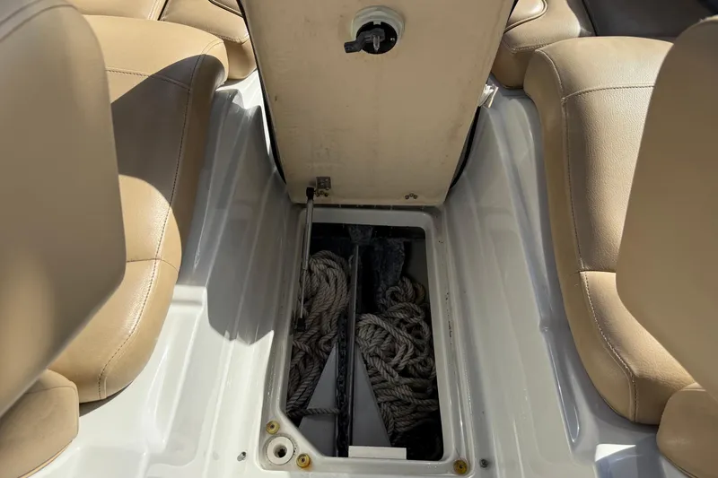 Slide: The Image of Open storage compartment on 2018 Crownline Eclipse E24 XS boat, showing interior space. - 52