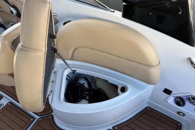 Slide: The Image of 2018 Crownline Eclipse E24 XS boat storage compartment with ropes, surrounded by beige seats. - 53