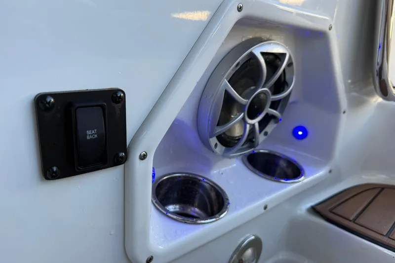 Slide: The Image of 2018 Crownline Eclipse E24 XS boat seat storage compartment open, revealing interior space. - 54