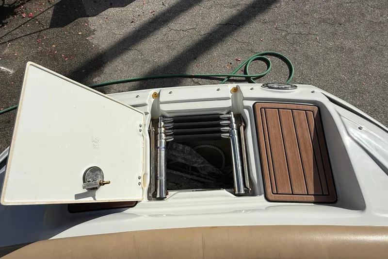 Slide: The Image of 2018 Crownline Eclipse E24 XS boat interior with speaker, cup holders, and seat back switch. - 55