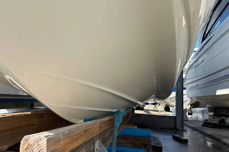Slide: The Image of 2018 Crownline Eclipse E24 XS boat hull in storage, viewed from the front. - 6