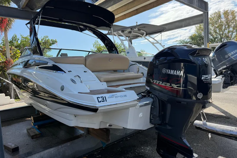 Slide: The Image of 2018 Crownline Eclipse E24 XS boat with "Sunshine Daydream" decal in a marina setting. - 9