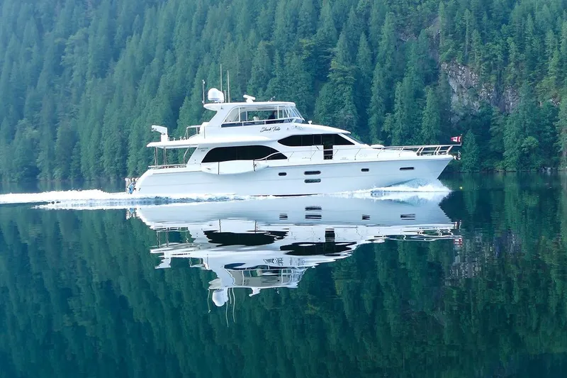 The Image of 2015 Hampton motor yacht cruising on a serene lake with forested backdrop. - 0