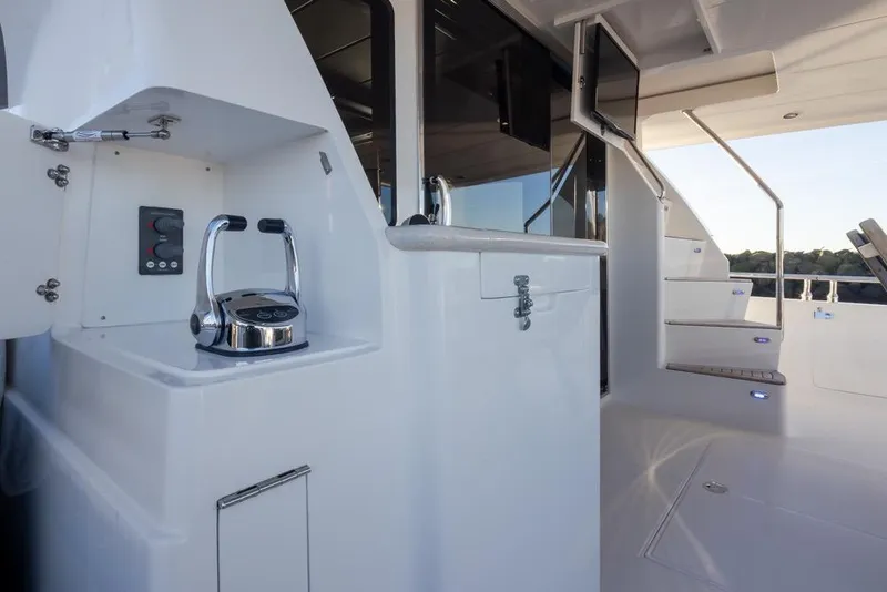 Slide: The Image of 2015 Hampton motor yacht interior with sleek controls and modern staircase design. - 10