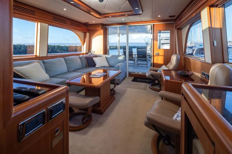 Slide: The Image of Luxurious interior of a 2015 Hampton motor yacht with elegant seating and panoramic windows. - 16