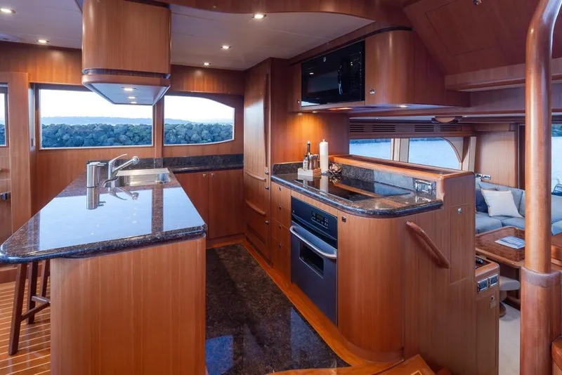 Slide: The Image of Luxurious 2015 Hampton motor yacht interior with modern kitchen and elegant wood finishes. - 21