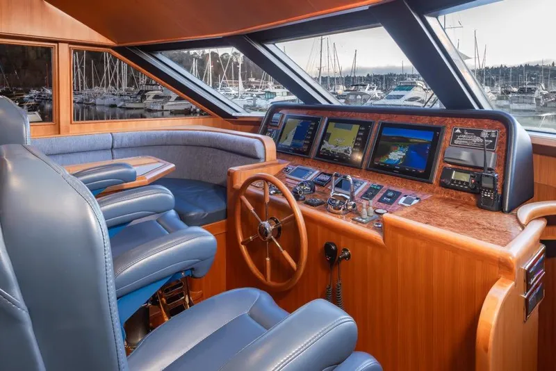 Slide: The Image of Luxurious 2015 Hampton motor yacht helm with advanced navigation systems and plush seating. - 26