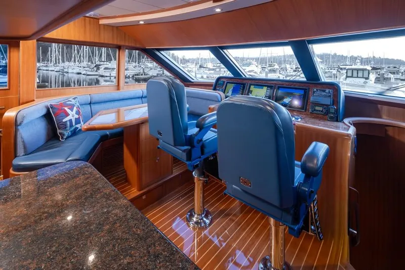 Slide: The Image of Luxurious 2015 Hampton motor yacht interior with helm, seating, and navigation equipment. - 28