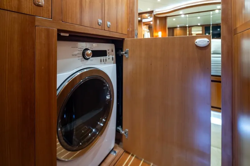 Slide: The Image of Laundry area inside 2015 Hampton motor yacht with wooden cabinetry. - 32