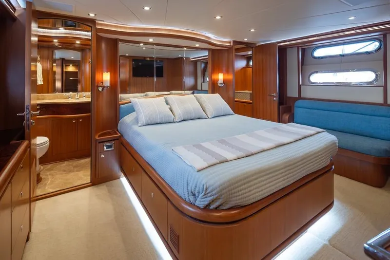 Slide: The Image of Luxurious 2015 Hampton motor yacht bedroom with elegant wood finish and modern amenities. - 34