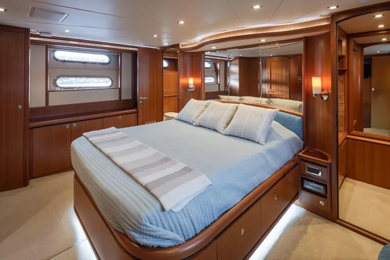 Slide: The Image of Luxurious bedroom interior of 2015 Hampton motor yacht with elegant wood finishes and soft lighting. - 35