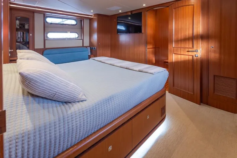 Slide: The Image of Luxurious bedroom interior of 2015 Hampton motor yacht with wooden finishes and cozy bedding. - 36