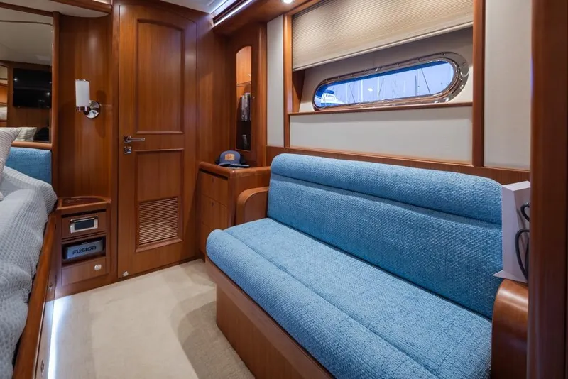 Slide: The Image of Luxurious 2015 Hampton motor yacht interior with blue seating and wooden accents. - 38