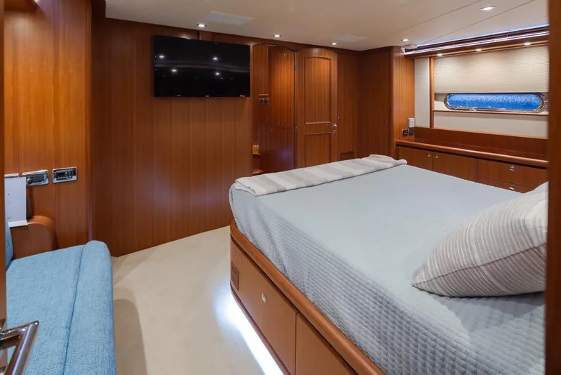 Slide: The Image of Luxurious 2015 Hampton motor yacht bedroom with wood paneling and modern amenities. - 39