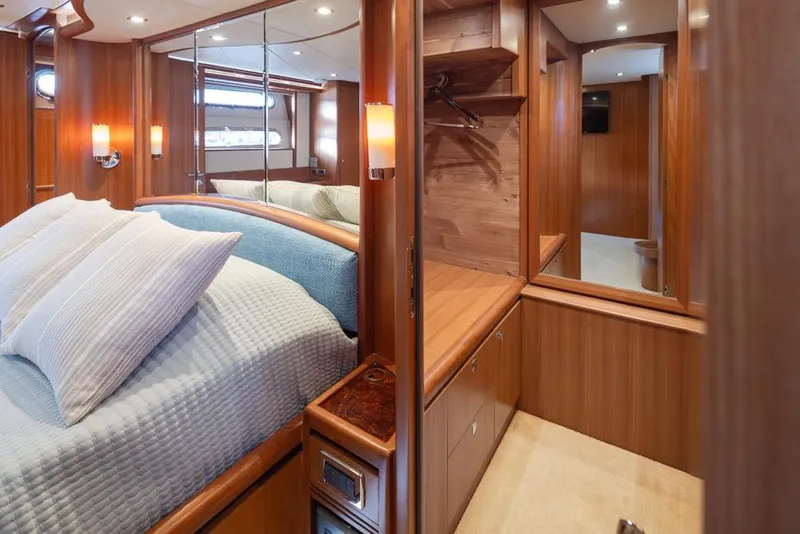 Slide: The Image of Luxurious 2015 Hampton motor yacht bedroom with elegant wood finishes and cozy bedding. - 40