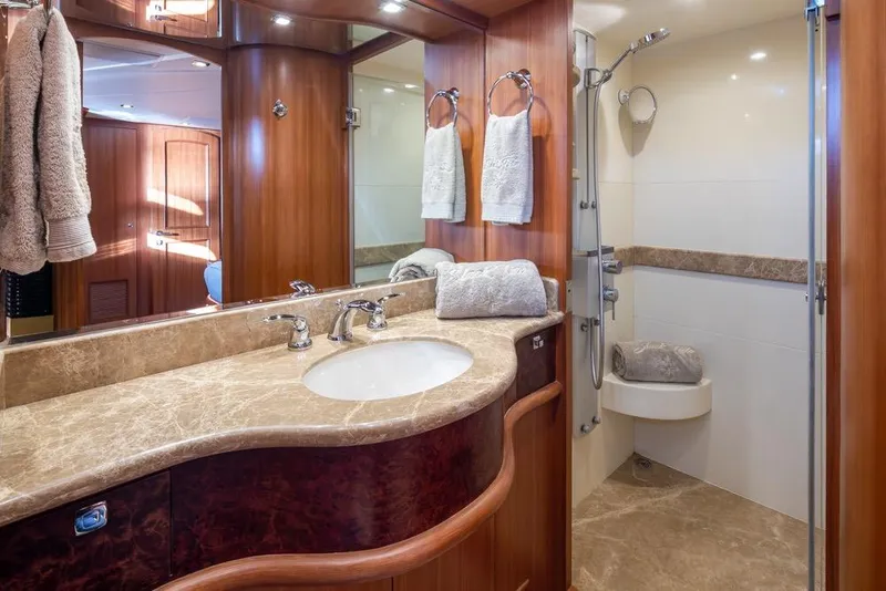 Slide: The Image of Luxurious bathroom in 2015 Hampton motor yacht with marble countertop and elegant wood finishes. - 42