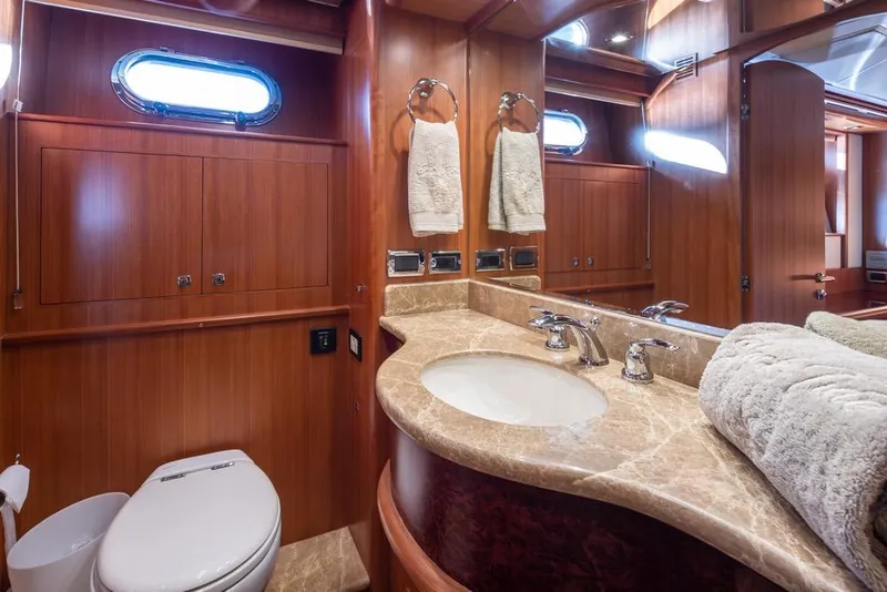 Slide: The Image of Luxurious bathroom in 2015 Hampton motor yacht with marble countertop and wooden cabinetry. - 43