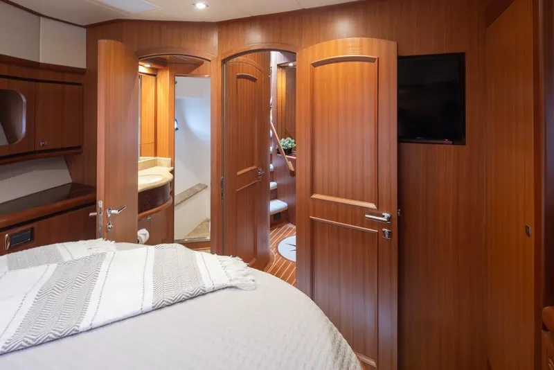 Slide: The Image of Luxurious 2015 Hampton motor yacht interior with wooden doors and cozy bedroom. - 48