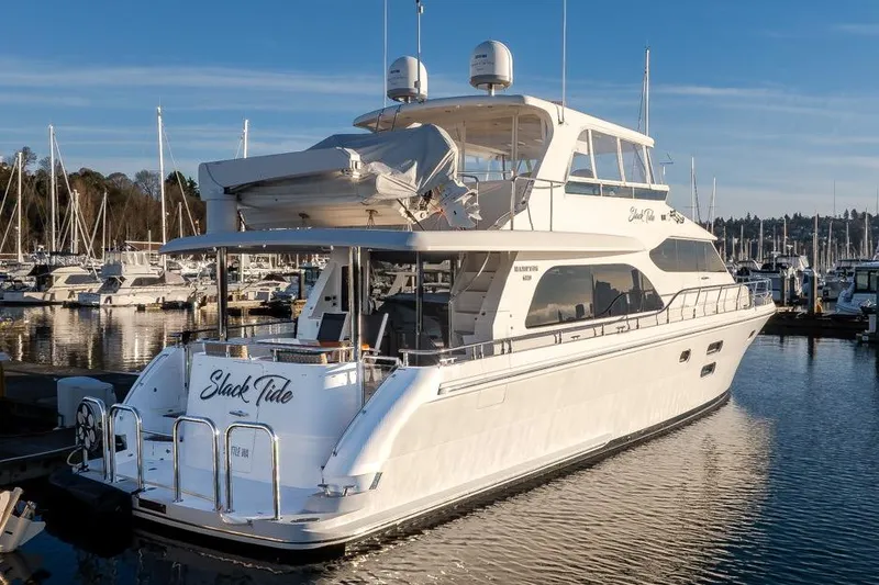 Slide: The Image of Luxurious 2015 Hampton motor yacht docked in a marina under clear blue skies. - 5