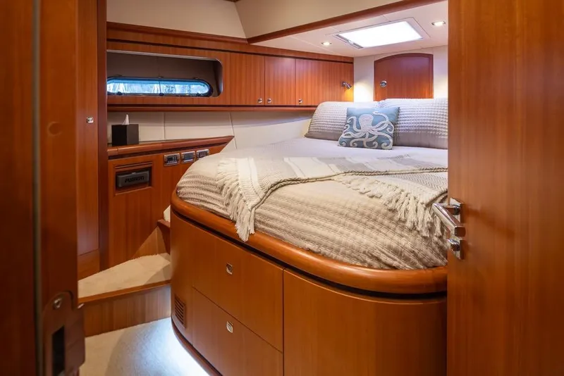 Slide: The Image of Luxurious 2015 Hampton motor yacht bedroom with elegant wood finish and cozy bedding. - 50
