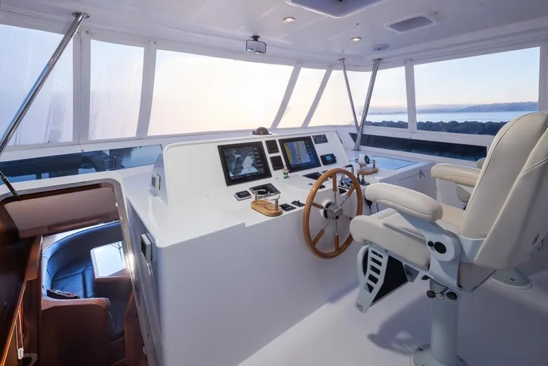 Slide: The Image of Luxurious 2015 Hampton motor yacht helm with panoramic windows and modern navigation equipment. - 54