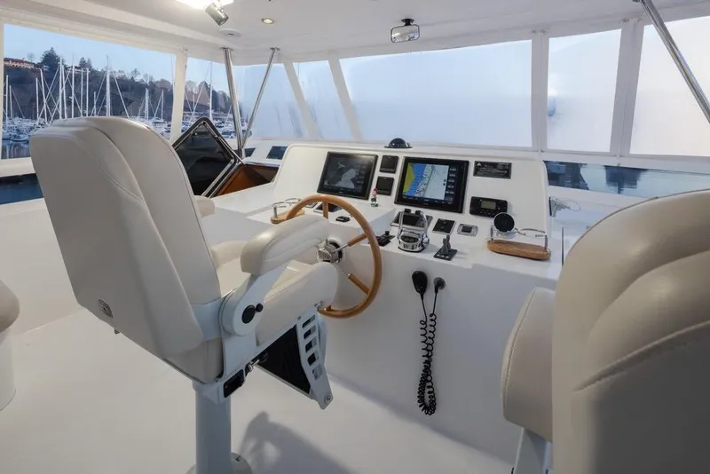 Slide: The Image of Luxurious 2015 Hampton motor yacht helm with modern navigation equipment and plush seating. - 55