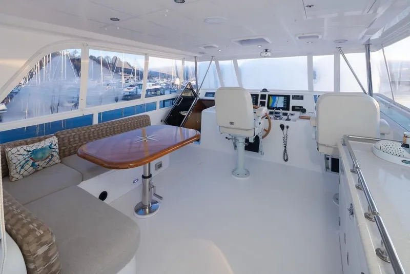 Slide: The Image of Luxurious 2015 Hampton motor yacht interior with helm, seating, and table. - 56