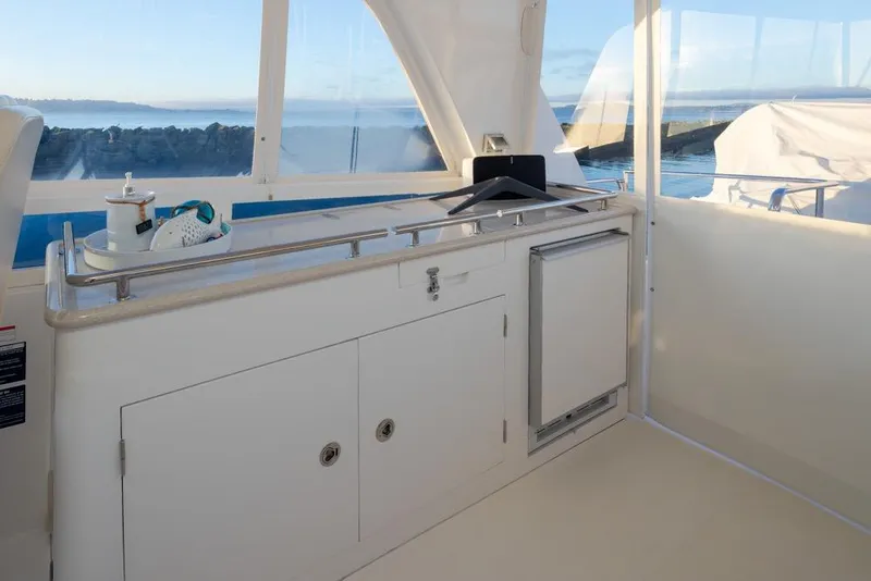 Slide: The Image of 2015 Hampton motor yacht interior with kitchenette and ocean view. - 57