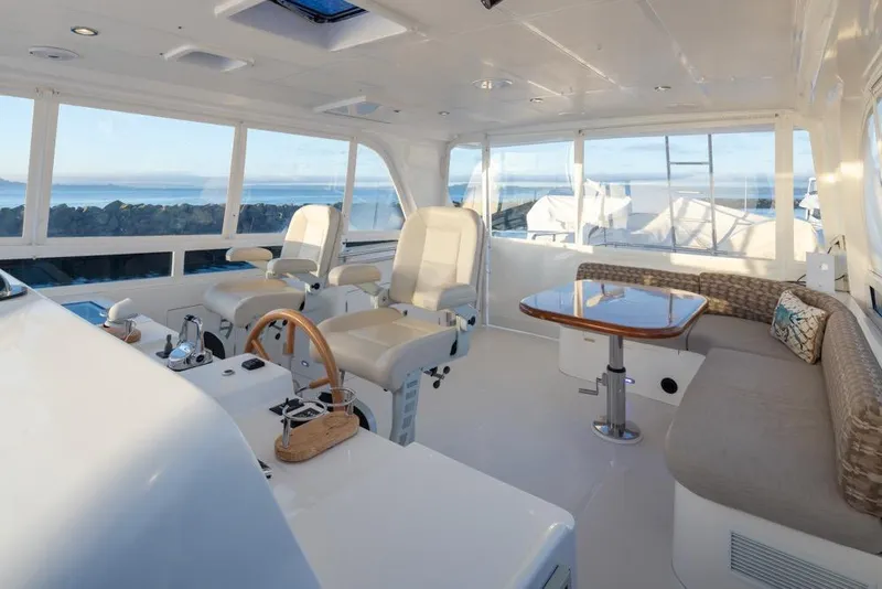 Slide: The Image of Luxurious 2015 Hampton motor yacht interior with helm, seating, and ocean view. - 58