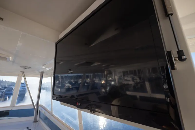 Slide: The Image of Flat-screen TV on 2015 Hampton motor yacht deck, overlooking marina. - 62