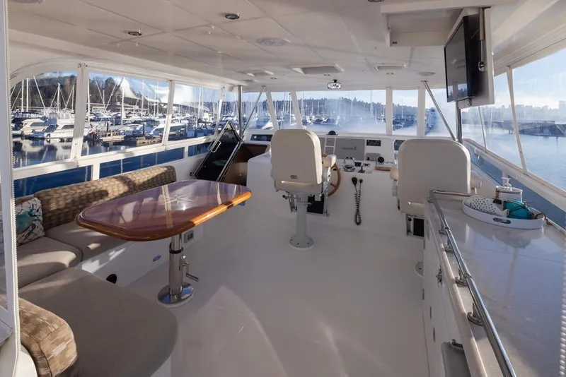 Slide: The Image of Luxurious 2015 Hampton motor yacht interior with helm, seating, and marina view. - 63
