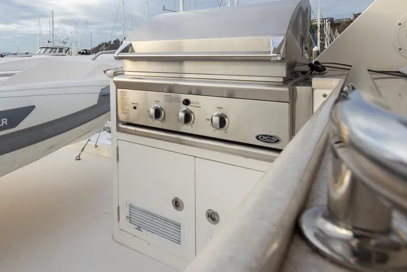Slide: The Image of Outdoor grill on 2015 Hampton motor yacht deck, with nearby boats in marina. - 66