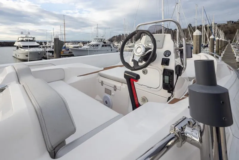 Slide: The Image of 2015 Hampton motor yacht interior with steering wheel, docked at marina. - 69