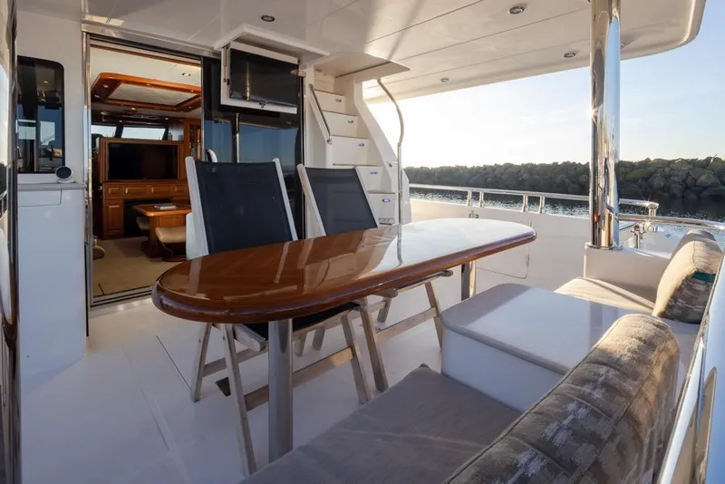 Slide: The Image of Luxurious 2015 Hampton motor yacht interior with elegant dining area and scenic ocean view. - 7