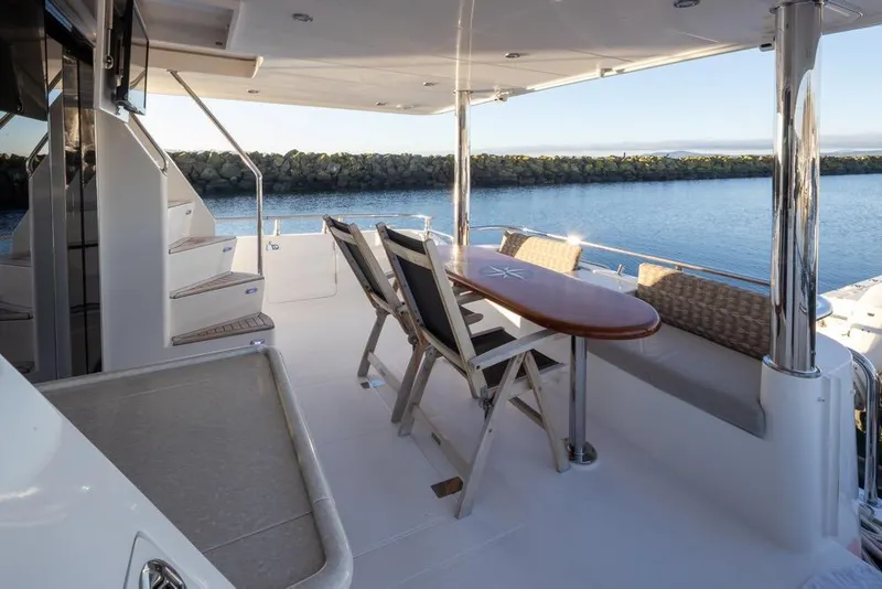 Slide: The Image of Luxurious 2015 Hampton motor yacht deck with seating and ocean view. - 8