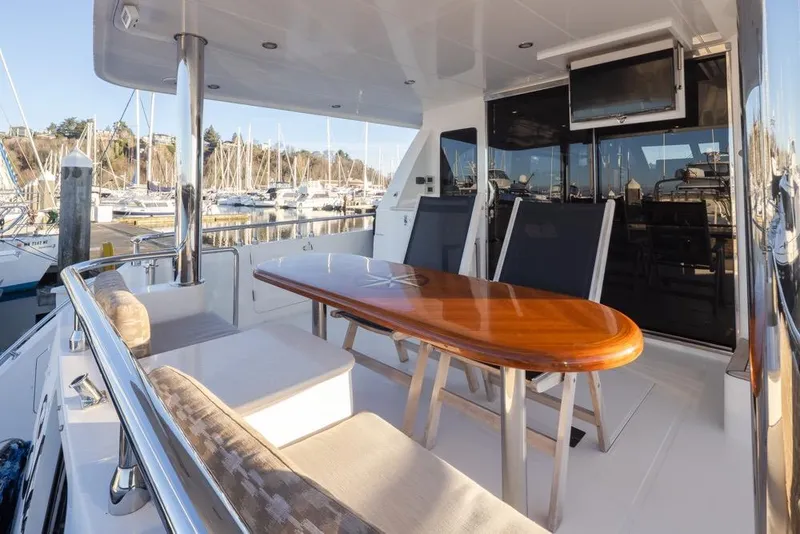 Slide: The Image of 2015 Hampton motor yacht with outdoor seating and marina view. - 9