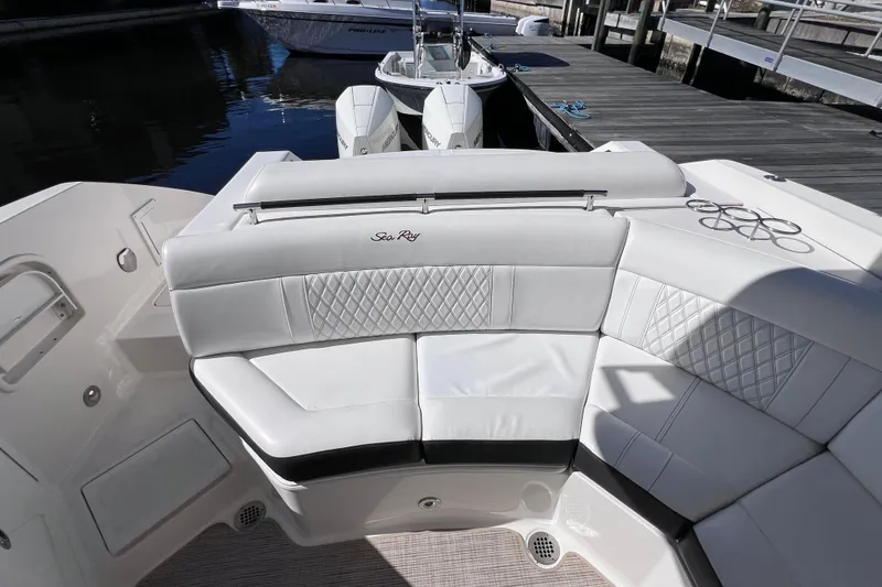 Slide: The Image of 2019 Sea Ray SLX 310 Outboard boat interior with control panel and dock view. - 19