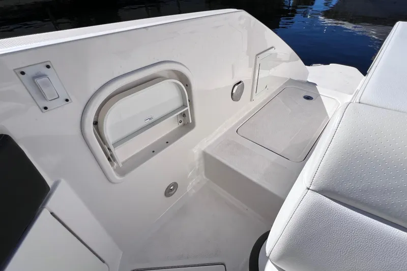 Slide: The Image of 2019 Sea Ray SLX 310 Outboard boat with luxurious white seating at a dock. - 20