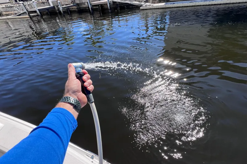 Slide: The Image of 2019 Sea Ray SLX 310 Outboard storage compartment with control panel, open hatch. - 23